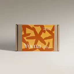 Χάρτινη συσκευασία YUMA Gold Orchid με πορτοκαλί και κίτρινα αφηρημένα σχέδια.