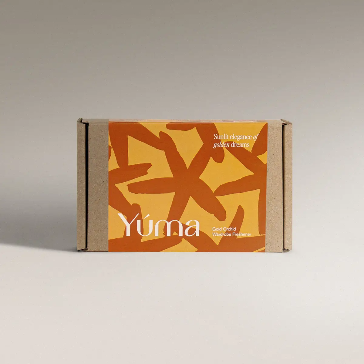 Χάρτινη συσκευασία YUMA Gold Orchid με πορτοκαλί και κίτρινα αφηρημένα σχέδια.