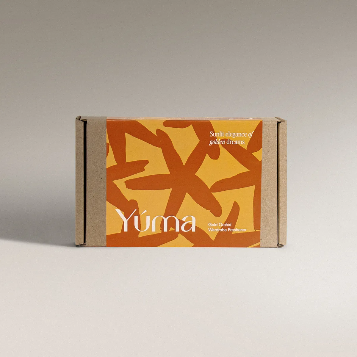 Gold Orchid Wax Tablets - Set of 2 Χάρτινη συσκευασία YUMA Gold Orchid με πορτοκαλί και κίτρινα αφηρημένα σχέδια.